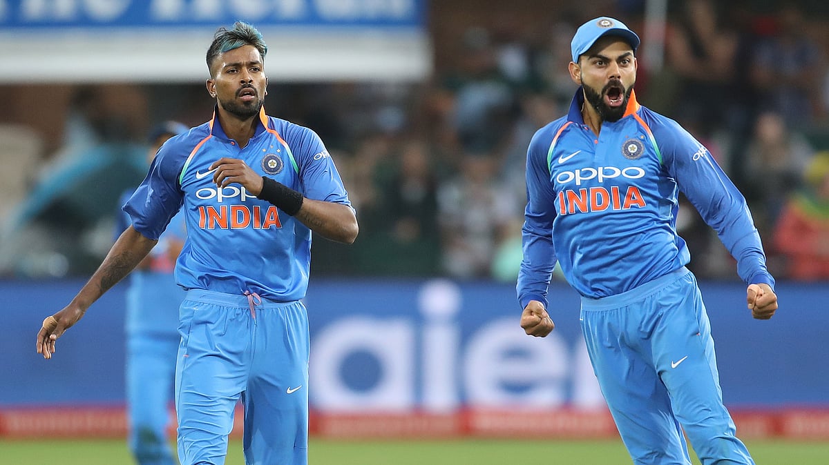 Virat Kohli celebrates a wicket with Hardik Pandya.