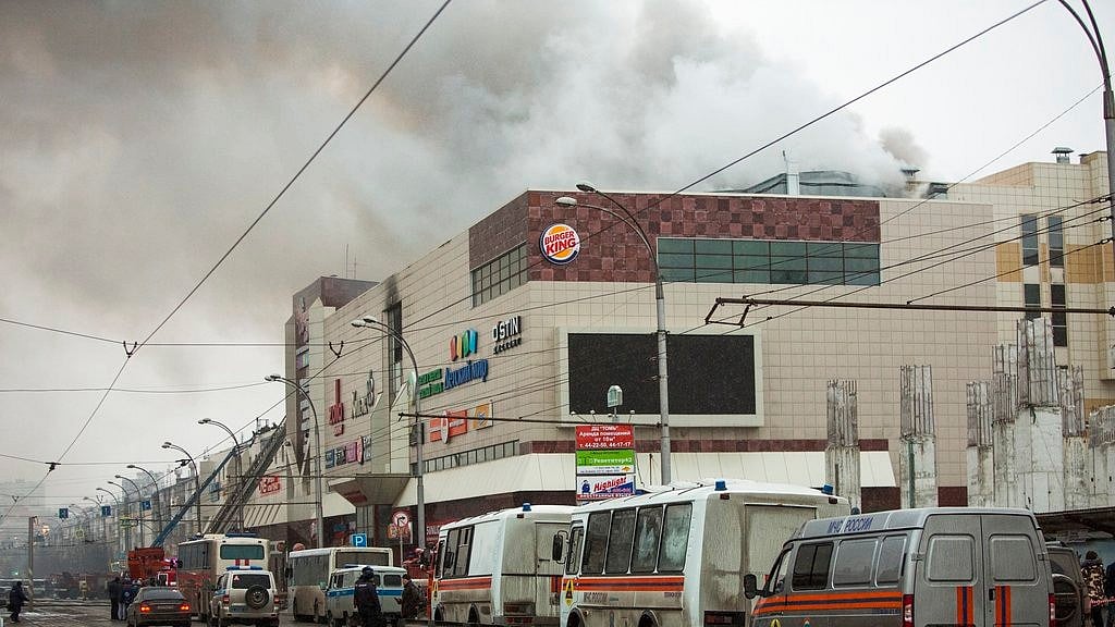 Smoke rises above a multi-storey shopping center in the Siberian city of Kemerovo, about 3,000 kilometers (1,900 miles) east of Moscow, Russia, on Sunday, March 25.
