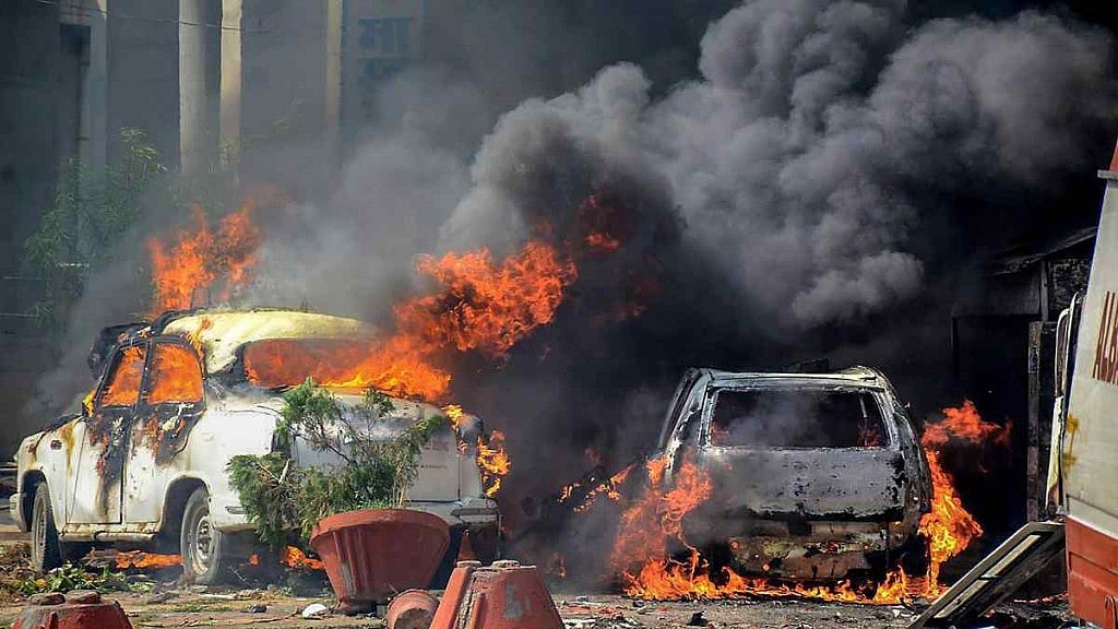 Smoke billows out of burning cars in Muzaffarnagar during the Dalit protests on 2 April 2018.