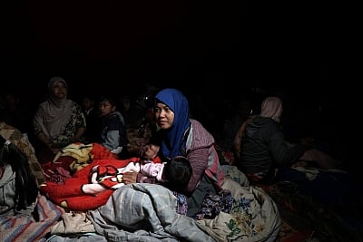 BANJARNEGARA, April 18, 2018 (Xinhua) --  A woman holds her baby in a temporary shelter in Banjarnegara, Central Java, Indonesia, April 18, 2018. A shallow earthquake hit Central Java province of western Indonesia on Wednesday, leaving one person dead and hundreds houses and buildings destroyed, a disaster agency official said. (Xinhua/IANS)