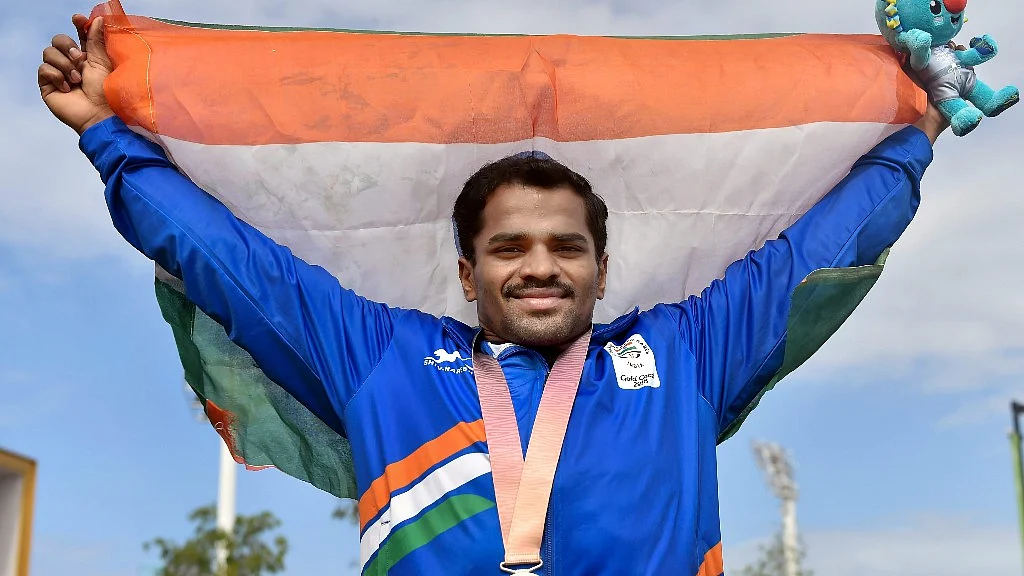 Indian weightlifter P Gururaja poses with the tricolour for a photo after winning silver in Men’s 56kg Weightlifting final during Commonwealth Games 2018 in Gold Coast on Thursday.&nbsp;