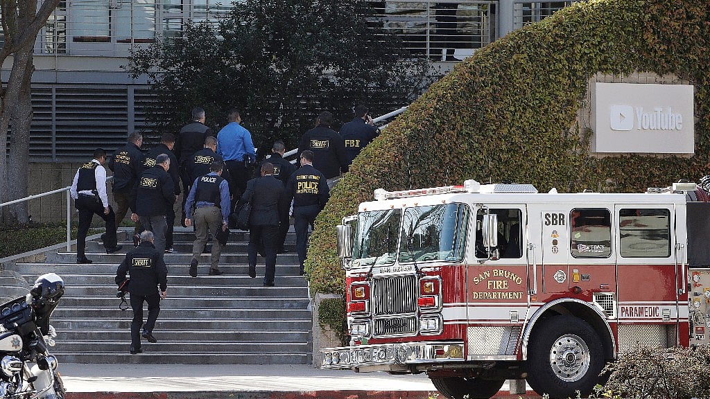 Law enforcement officials walk inside the YouTube office in San Bruno, California.