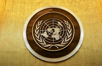 Plaque bearing the United Nations logo above the podium of the General Assembly Hall. (File Photo: Ryan Brown/UN Photo/IANS)