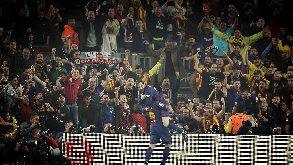 Football fans in Spain take the sport to the next level. Seen here, Lionel Messi celebrating a goal for Barcelona with Luis Suarez.