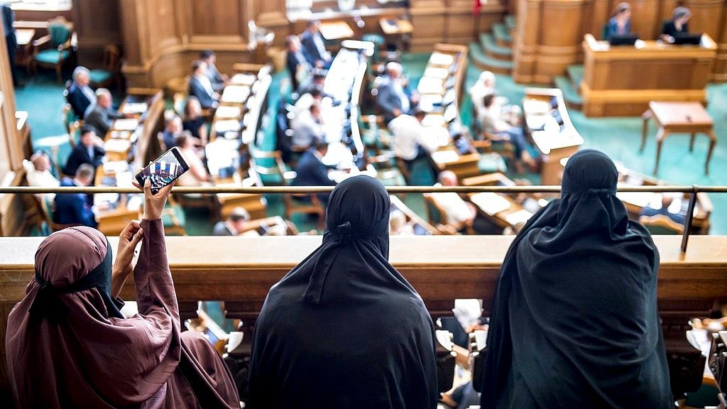 Women wearing the Islamic veil, niqab, sit in the audience seats of the Danish Parliament at Christiansborg Castle in Copenhagen, Denmark on Thursday, 31 May 2018.