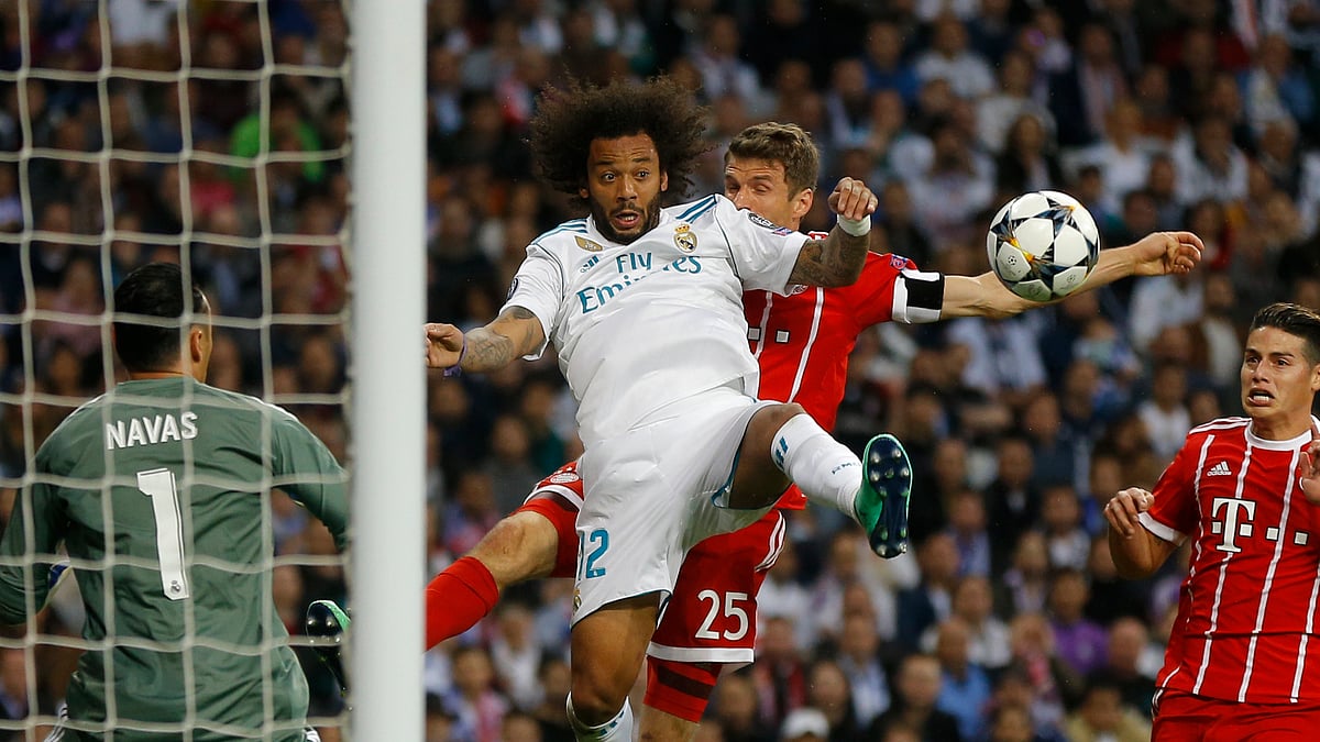 Real Madrid’s Marcelo and Bayern’s Thomas Mueller challenge for the ball during the Champions League match between Real Madrid and FC Bayern Munich at the Santiago Bernabeu.