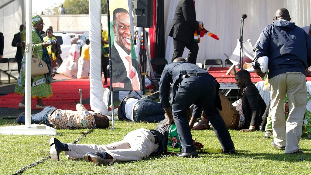 Injured people lay on the ground following an explosion at the President’s rally in Bulawayo, Zimbabwe on Saturday, 23 June.