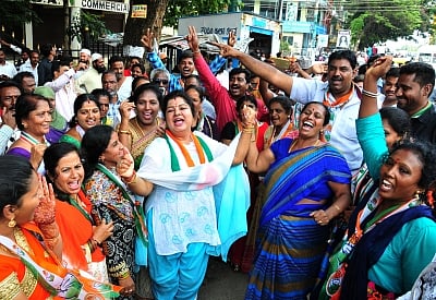 Bengaluru: Congress workers celebrate after Congress candidate Muniratna won Rajarajeshwari Nagar assembly seats in the bypoll; in Bengaluru on May 31, 2018. (Photo: IANS)