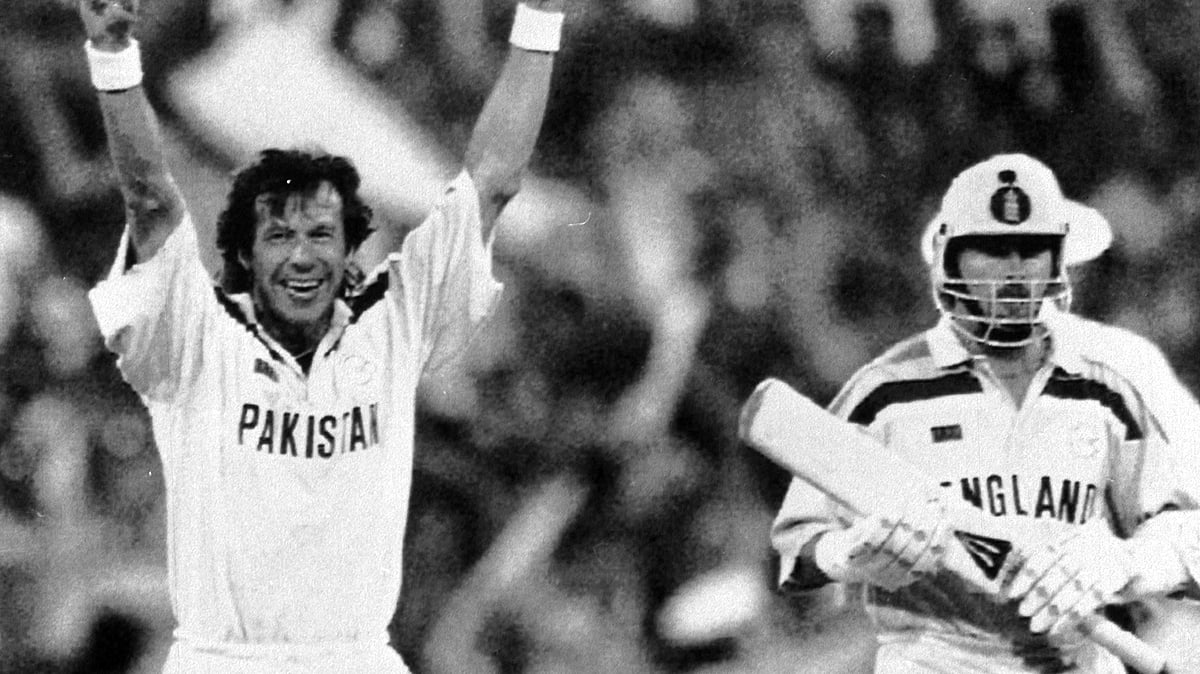 In this March 25, 1992 file photo, Pakistan captain Imran Khan, left, raises his arms in triumph, as England’s last batsman Richard Illingworth, right,  walks away after being given out, during the World Cup Cricket Final, in Melbourne, Australia.
