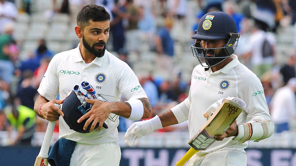 Virat Kohli and Dinesh Karthik walk off the ground during first Test against England.