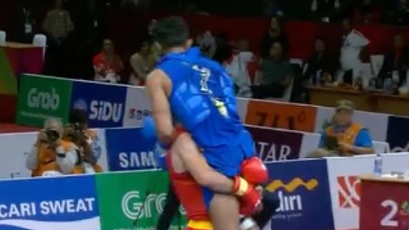 Iran’s Erfan Ahangarian carries India’s injured Surya Bhanu Pratap Singh after their Wushu match at the Asian Games.