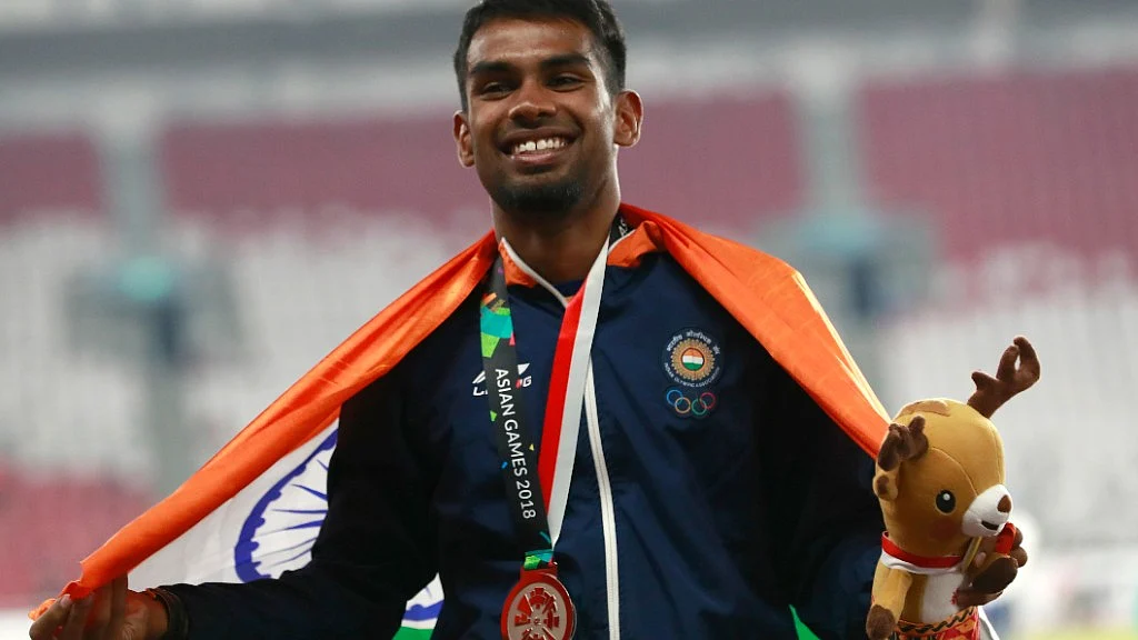 Dharun Ayyasamy celebrates after winning silver at Asian Games.