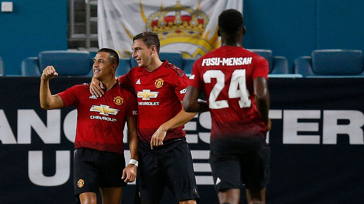 Manchester United midfielder Alexis Sanchez, left, celebrates his goal with teammates during the first half of the International Champions Cup tournament soccer match against Real Madrid.