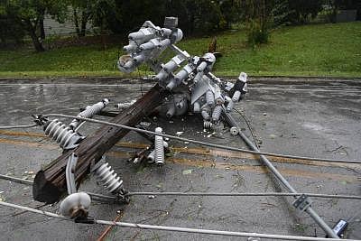 WASHINGTON, Sept. 15, 2018 (Xinhua) -- A fallen wire pole lies on a road in River Bend, North Carolina, the United States, on Sept. 14, 2018. At least five people have been killed so far in the aftermath of Hurricane Florence which was downgraded Friday afternoon to a tropical storm with winds of 70 mph (110 km/h) along the U.S. East Coast. (Xinhua/Liu Jie/IANS)
