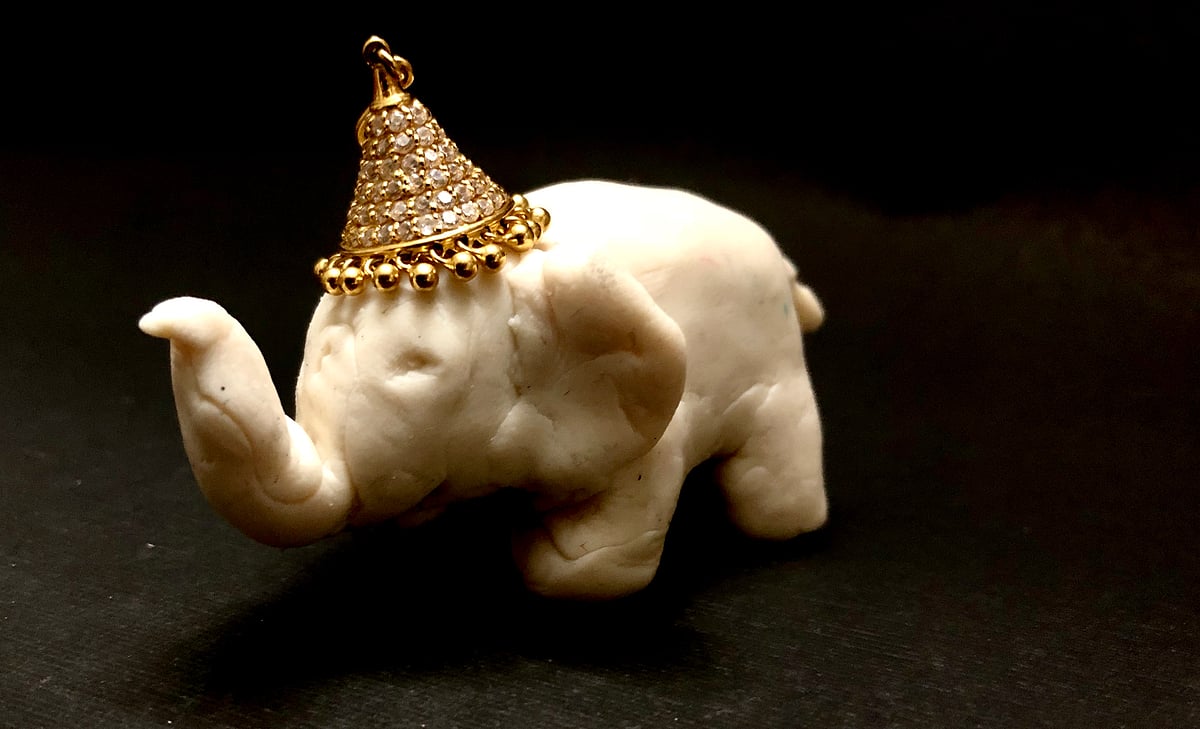 Ganesha in a photo shoot, in a white avatar.