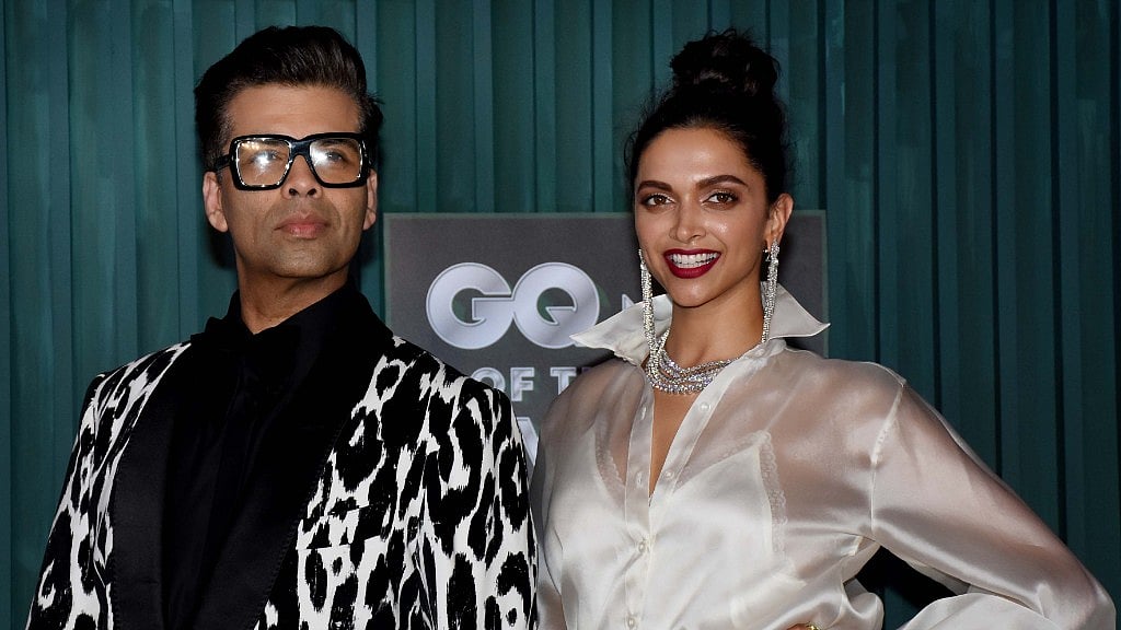 Karan Johar and Deepika Padukone strike a pose on the red carpet.&nbsp;