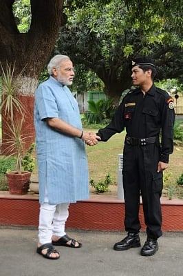 Laksham Singh Bisht with Narendra Modi while serving as NSG Commando.
