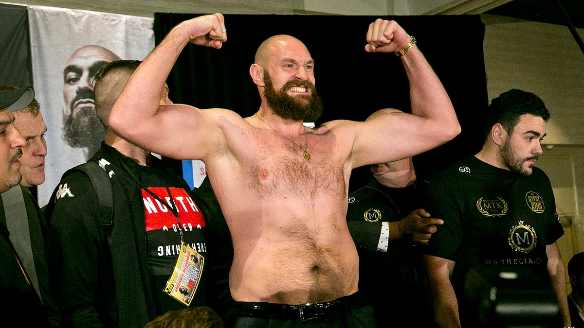Boxer Tyson Fury flexes after exchanging words with opponent Deontay Wilder at a news conference in Los Angeles, Wednesday, Nov. 28, 2018, ahead of their heavyweight world championship boxing match at Staples Center, on Dec. 1.&nbsp;