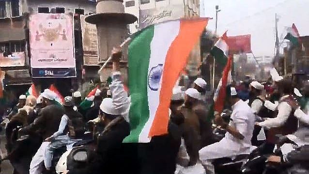 Men on bikes waving the tricolour to celebrate Republic Day.&nbsp;