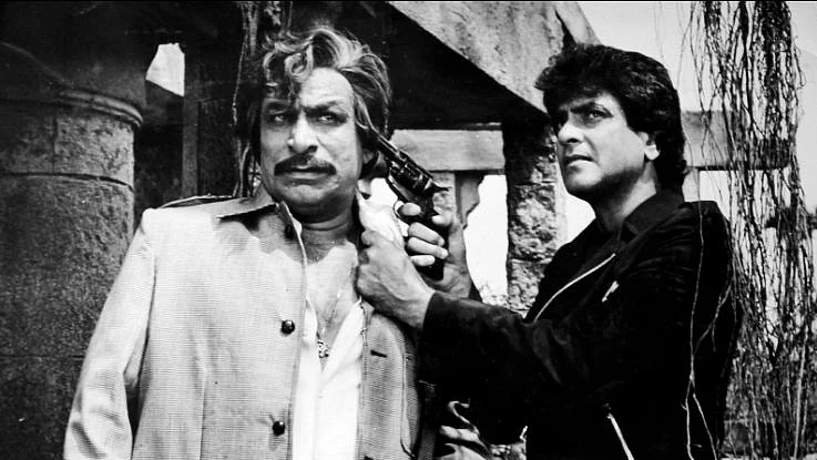 Bad guy Kader Khan gets cornered by good guy Jeetendra.