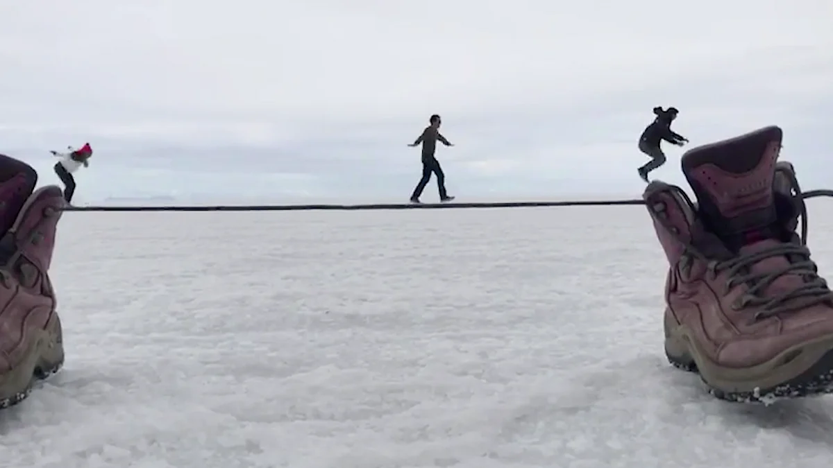 Optical illusion of people walking on a shoestring.