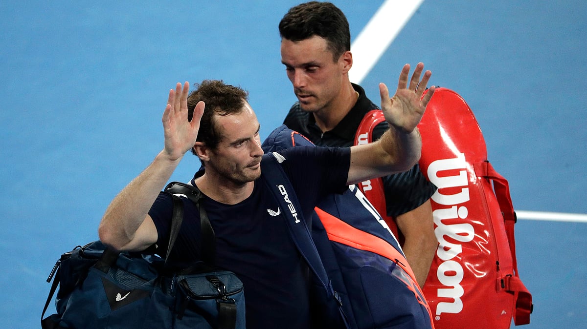 Britain’s Andy Murray, left, waves as he leaves the court following his first round loss to Spain’s Roberto Bautista Agut, right, at the Australian Open tennis championships in Melbourne, Australia, Monday, Jan. 14, 2019. 