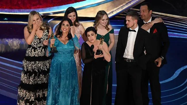  <i>Period. End of Sentence</i> team accepts the award.