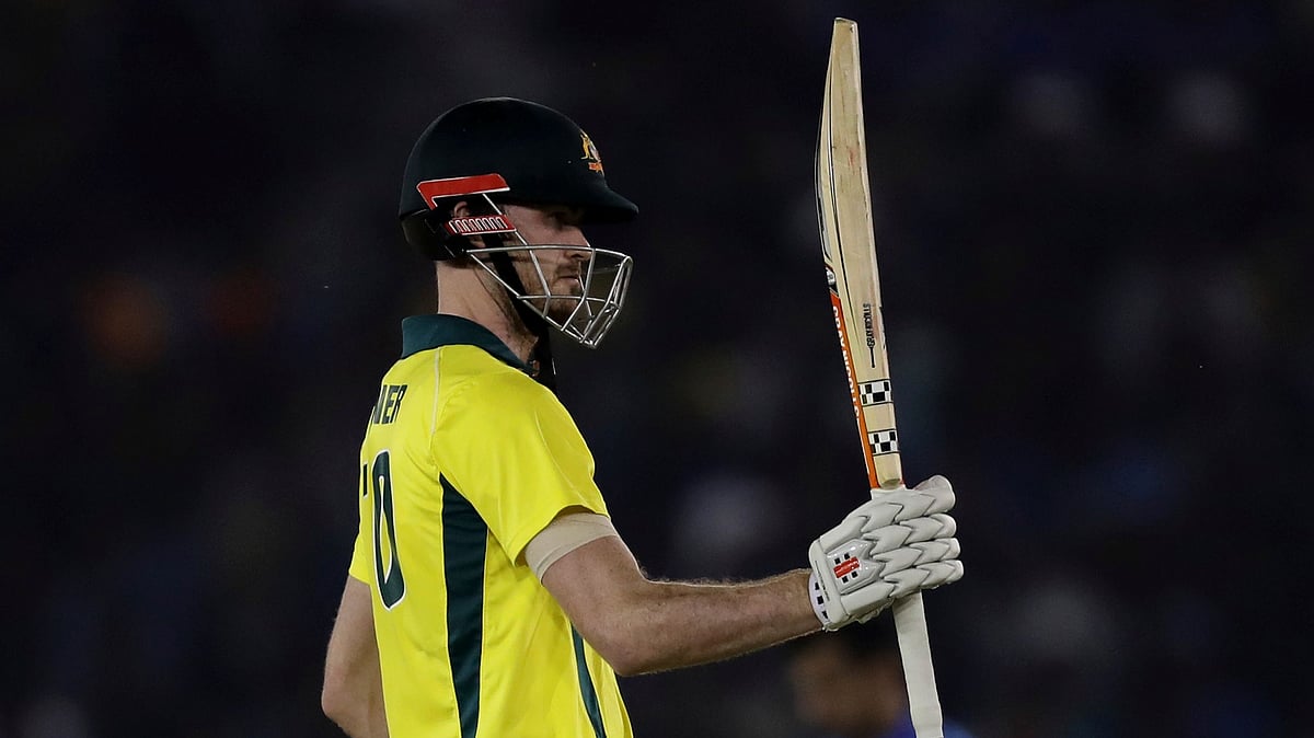Australia’s Ashton Turner raises his bat to celebrate scoring a fifty during the fourth ODI between India and Australia in Mohali.