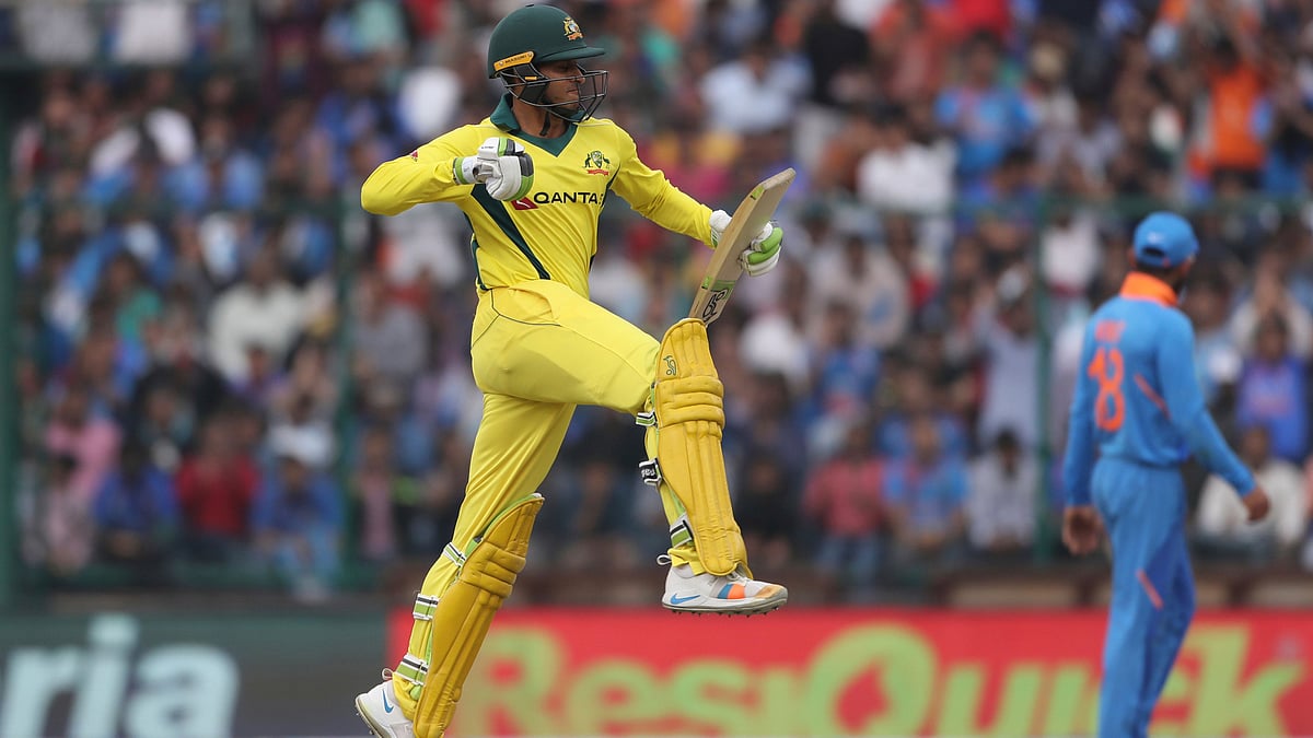 Usman Khawaja celebrates after reaching a 100 during the series-deciding fifth ODI between India and Australia at New Delhi.&nbsp;