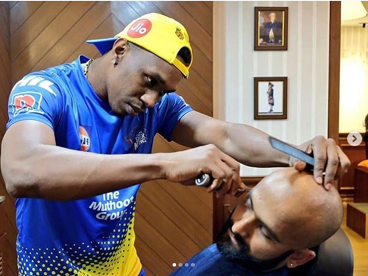 Dwayne Bravo giving Monu Singh a makeover.