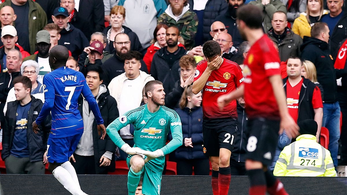 Manchester United goalkeeper David de Gea sits dejected after Chelsea’s Marcos Alonso, not pictured, scores his side’s first goal of the game during their English Premier League soccer match.