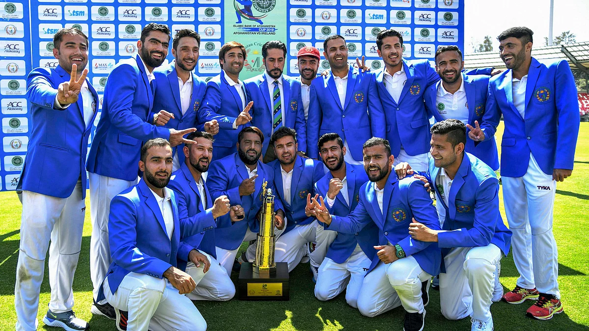 Dehradun: Afghanistan cricket team members pose with the winning trophy after their first Test win beating Ireland by seven wickets.