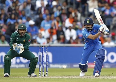 Manchester: Indian skipper Virat Kohli in action during the 22nd match of 2019 World Cup between India and Pakistan at Old Trafford in Manchester, England on June 16, 2019. Also seen Pakistani skipper Sarfaraz Ahmed. (Photo: Surjeet Yadav/IANS)