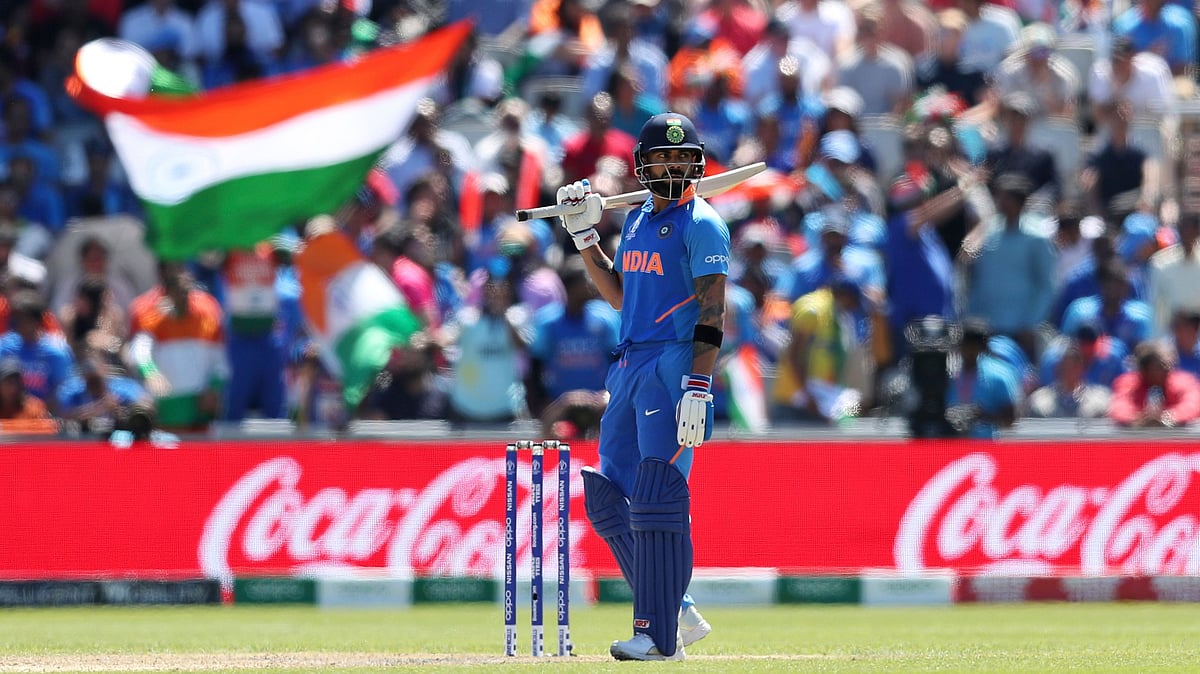 India’s captain Virat Kohli follows the ball after playing a shot during the Cricket World Cup match between India and West Indies at Old Trafford.