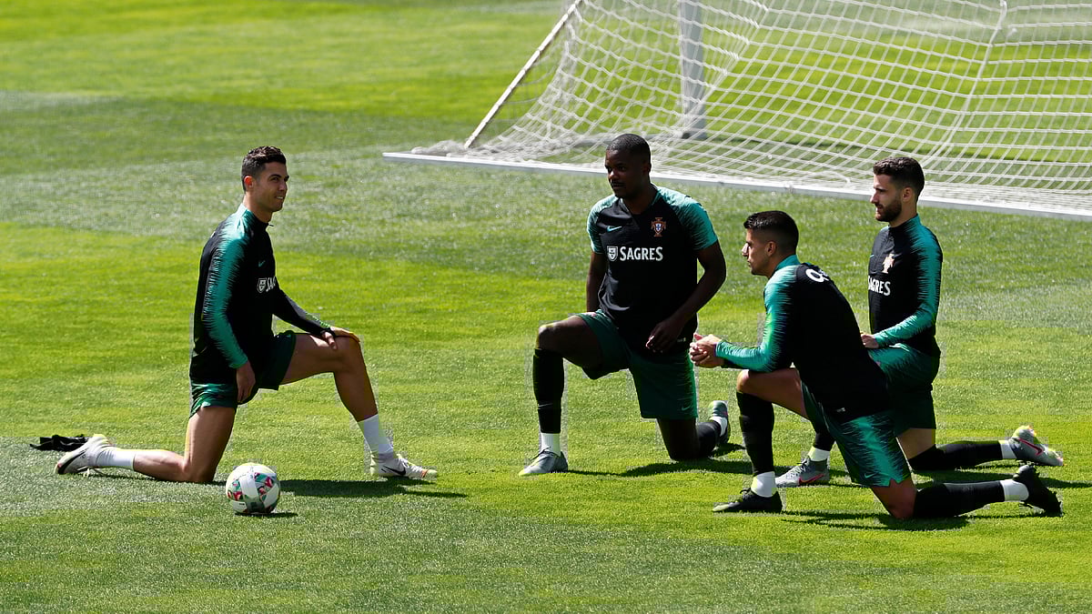 From left, Portugal’s Cristiano Ronaldo, William Carvalho, Joao Cancelo and Rafa Silva stretch during a training session.