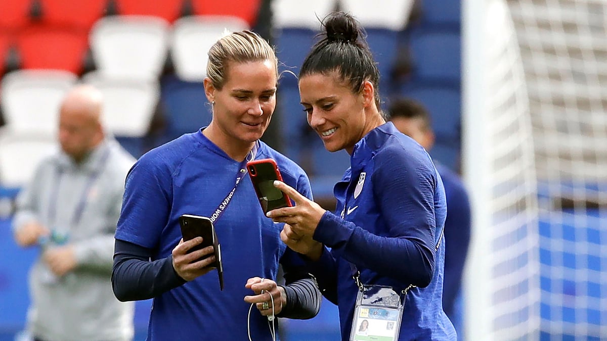 In this 15 June  2019, file photo, US teammates Ashlyn Harris, left, and Ali Krieger chat during a visit to the Parc des Princes stadium a day before a soccer match against Chile.&nbsp;