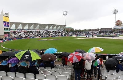 Nottingham: Spectators shield themselves with umbrellas at the Trent Bridge Cricket Ground during rains that delayed the 18th Match of World Cup 2019 between India and New Zealand in Nottingham, England on June 13, 2019. (Photo: Surjeet Yadav/IANS)