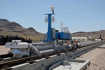 LAS VEGAS, May 12, 2016 (Xinhua) -- A recovery vehicle and a test sled sit on rails after a propulsion open-air test of Hyperloop One