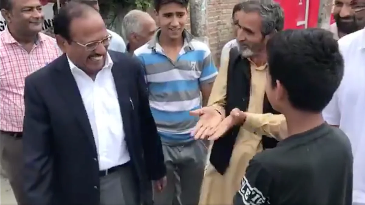 NSA Ajit Doval chats with a boy in a market in Anantnag on Saturday, 10 August
