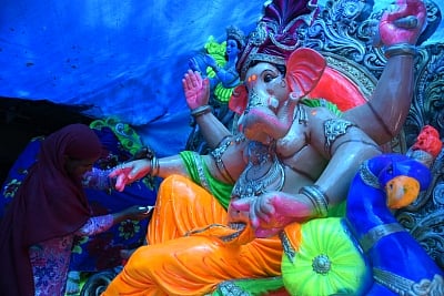 New Delhi: An artist gives finishing touches to idols of Lord Ganesha ahead of Ganesh Chaturthi in New Delhi on Aug 30, 2019. (Photo: Bidesh Manna/IANS)