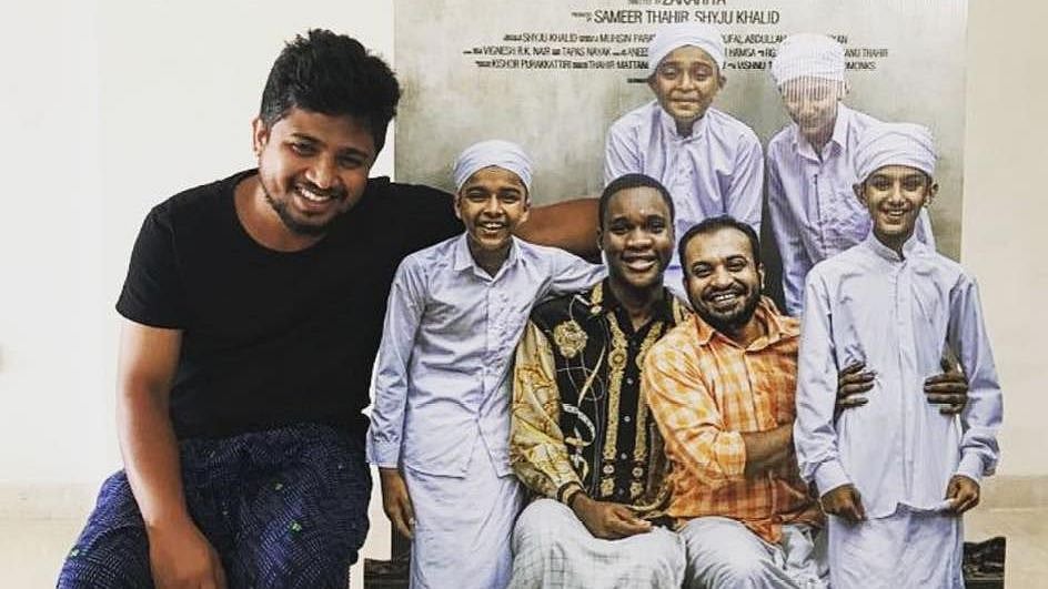 Zakariya Mohammed poses with the poster of his film <i>Sudani from Nigeria.</i>