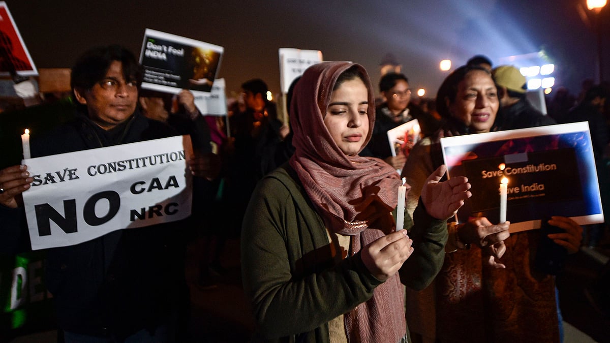 Protesters stage a candle light march against the amended Citizenship Act