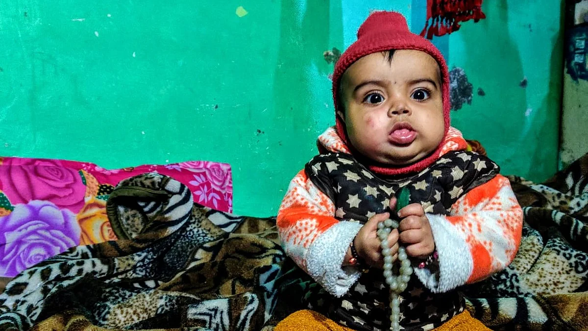 Anas’ seven-month-old son Adeeb Anas plays with the prayer beeds of his mother Bushra.&nbsp;