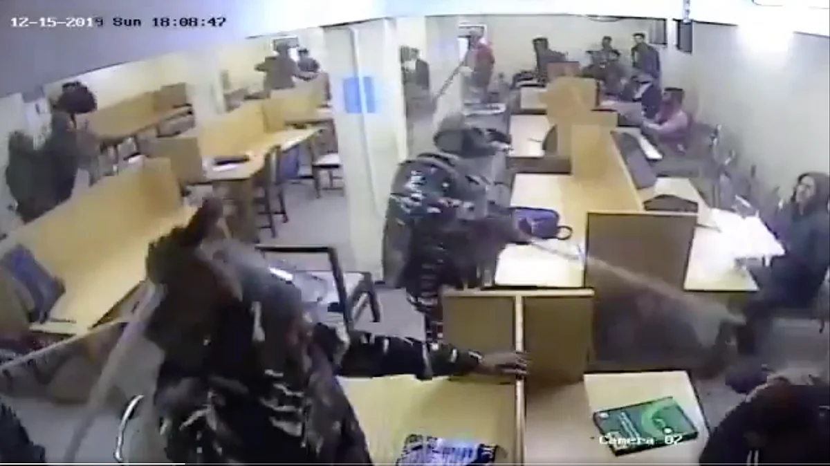 Armed policemen enter the reading hall and beat up students.