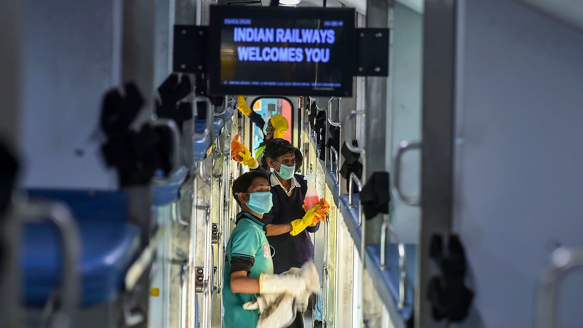 Railway workers disinfect the coaches of Delhi-Jammu Rajdhani Express train in the wake of coronavirus pandemic at New Delhi Railway Station.