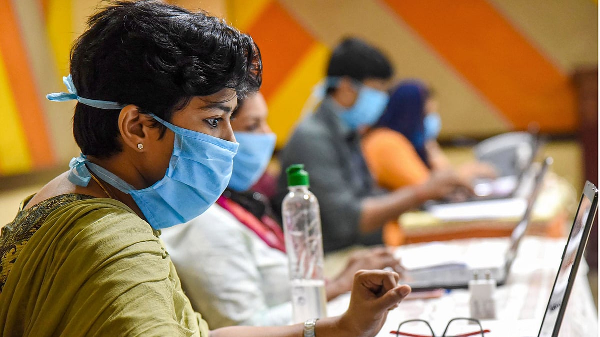  Employees of Health Tele Helpline center wearing face masks are seen working during a nationwide lockdown in the wake of coronavirus pandemic, at IMA house Ernakulam District in Kochi, Saturday, 18 April, 2020.&nbsp;