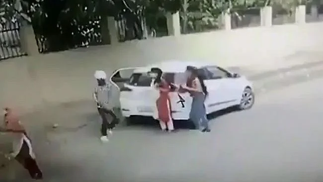 The woman was shot dead after she resisted a man’s attempts to shove her into a car.