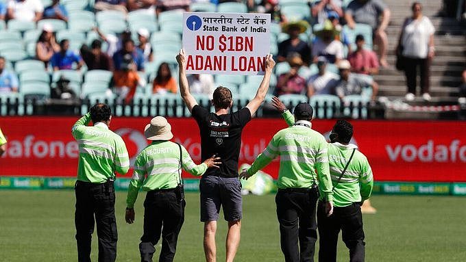 A protestor being escorted off the ground in Sydney.&nbsp;