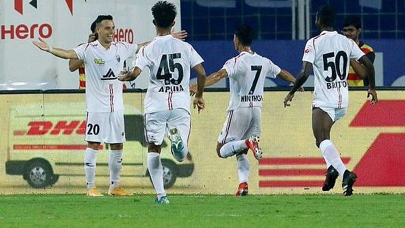 NorthEast United FC players celebrate a goal against Bengaluru FC.