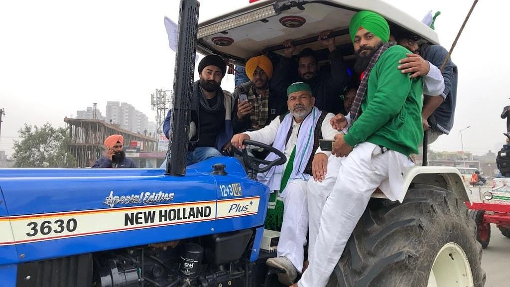Farmers hold a tractor rally during their ongoing protest against the new farm laws, at Ghazipur Border in New Delhi.